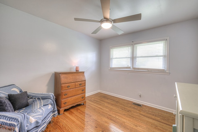 living area with light hardwood / wood-style flooring and ceiling fan