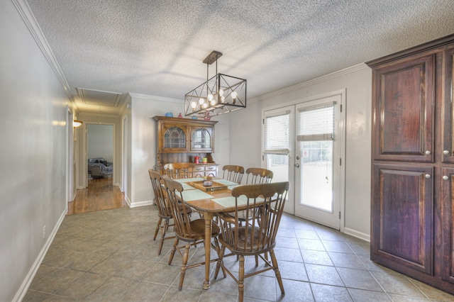 dining room featuring an inviting chandelier, a textured ceiling, light tile patterned flooring, and crown molding