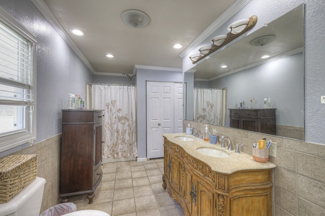 bathroom with toilet, vanity, tile patterned floors, and crown molding