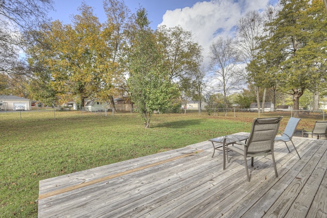 wooden terrace featuring a lawn