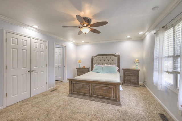 carpeted bedroom with ceiling fan and ornamental molding