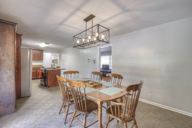 tiled dining room featuring ornamental molding, a textured ceiling, and an inviting chandelier