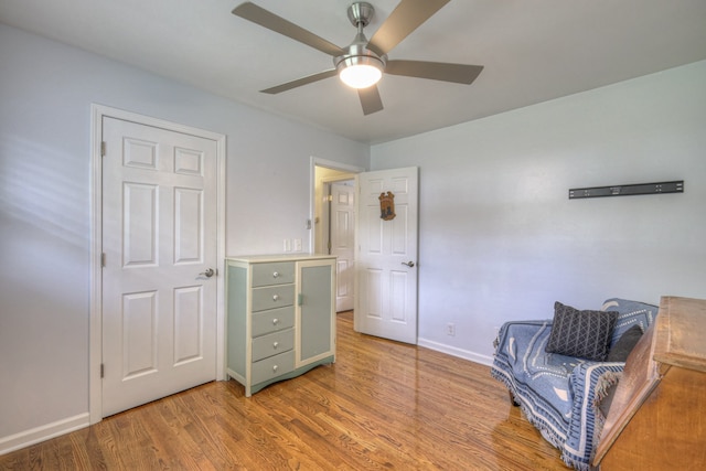 sitting room featuring light hardwood / wood-style floors and ceiling fan