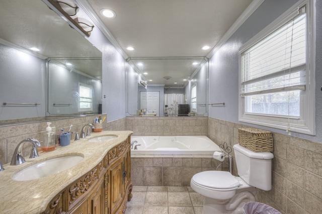 bathroom featuring a relaxing tiled tub, vanity, crown molding, tile patterned floors, and toilet