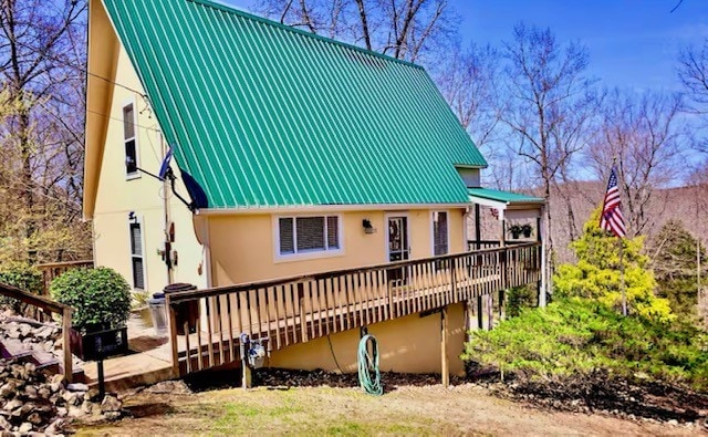 back of house with a deck