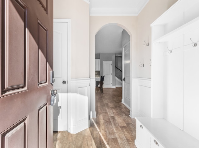 mudroom with light wood-type flooring and ornamental molding