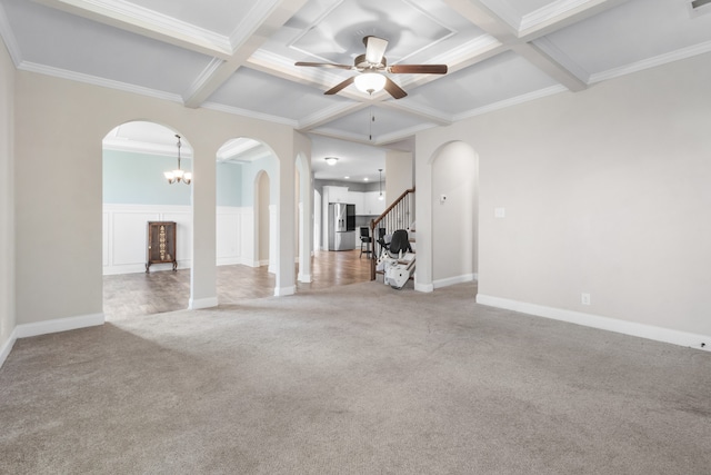 unfurnished living room with crown molding, beamed ceiling, carpet, and ceiling fan with notable chandelier