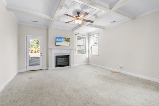 unfurnished living room with light carpet, beamed ceiling, ceiling fan, and ornamental molding