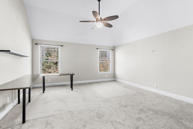 interior space with ceiling fan, lofted ceiling, and light carpet