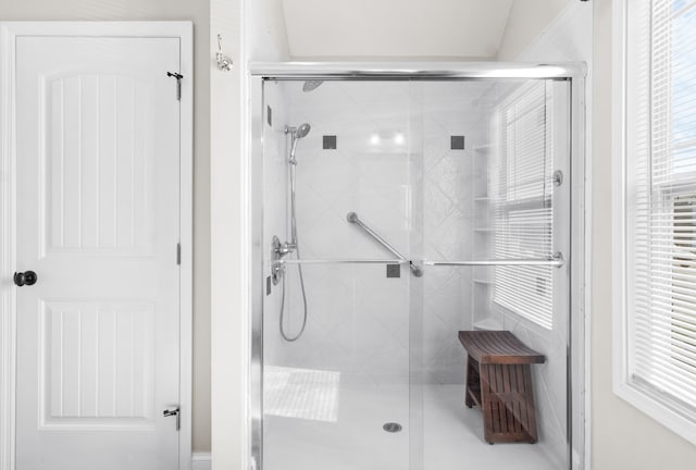 bathroom featuring a shower with door