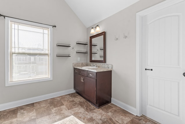 bathroom with vanity and lofted ceiling