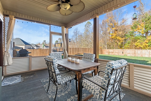 sunroom / solarium with ceiling fan and wood ceiling