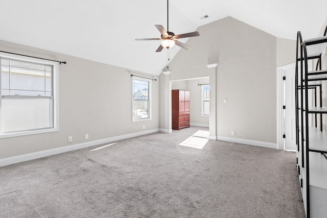 spare room featuring light colored carpet, high vaulted ceiling, and ceiling fan