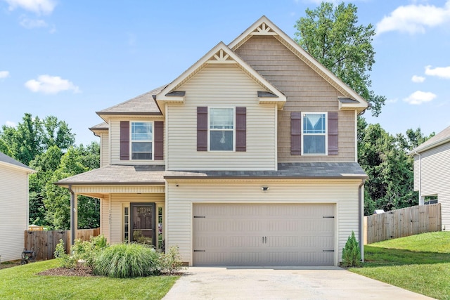 craftsman house with a garage and a front lawn