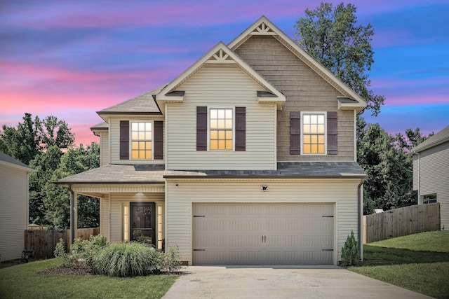 view of front of house featuring a yard and a garage