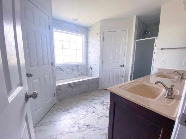 bathroom featuring vanity and tiled shower / bath combo