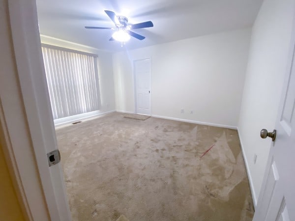 spare room featuring ceiling fan and carpet floors