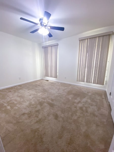 empty room with carpet and ceiling fan