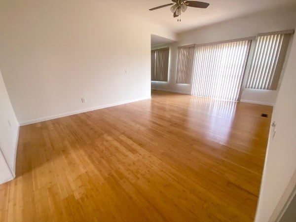 unfurnished room with light wood-type flooring and ceiling fan