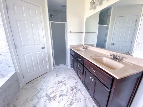 bathroom featuring vanity and an enclosed shower