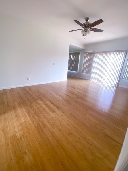 spare room with light hardwood / wood-style floors and ceiling fan