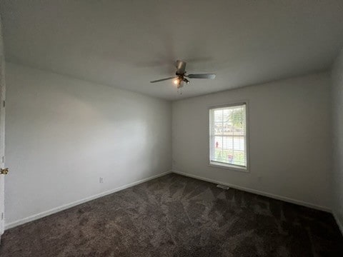 carpeted empty room featuring ceiling fan