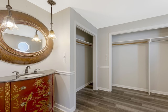 bathroom with hardwood / wood-style floors and vanity