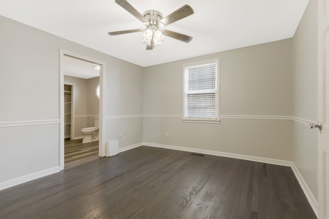 spare room featuring dark hardwood / wood-style floors and ceiling fan