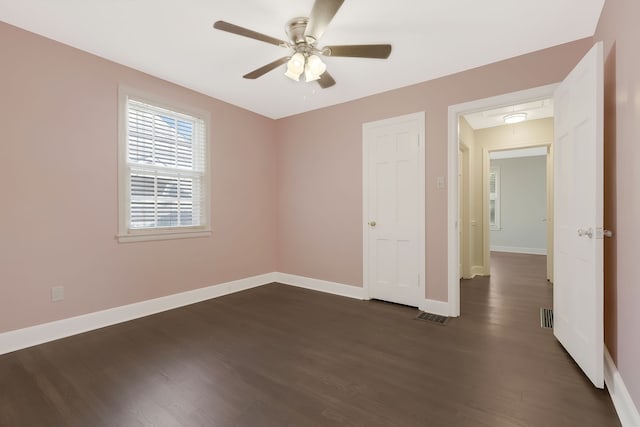 spare room featuring ceiling fan and dark wood-type flooring