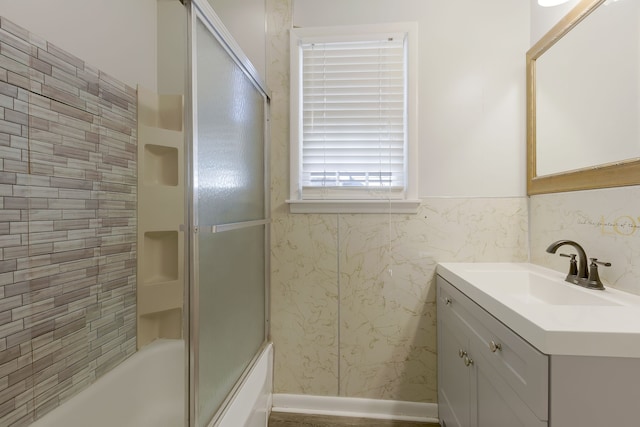 bathroom with vanity and enclosed tub / shower combo