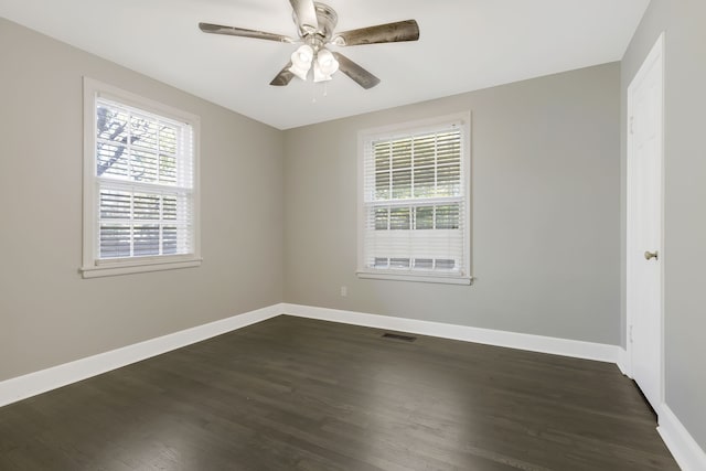 unfurnished room with ceiling fan and dark hardwood / wood-style flooring