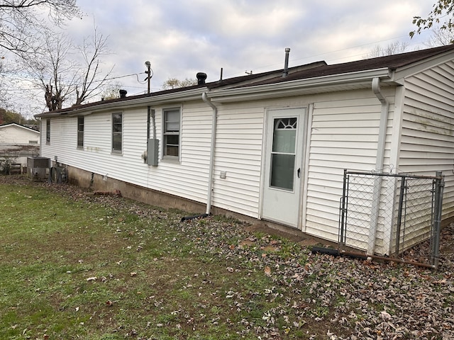 rear view of house featuring a yard