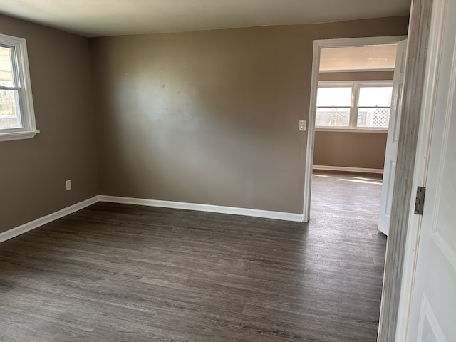 spare room with dark hardwood / wood-style flooring