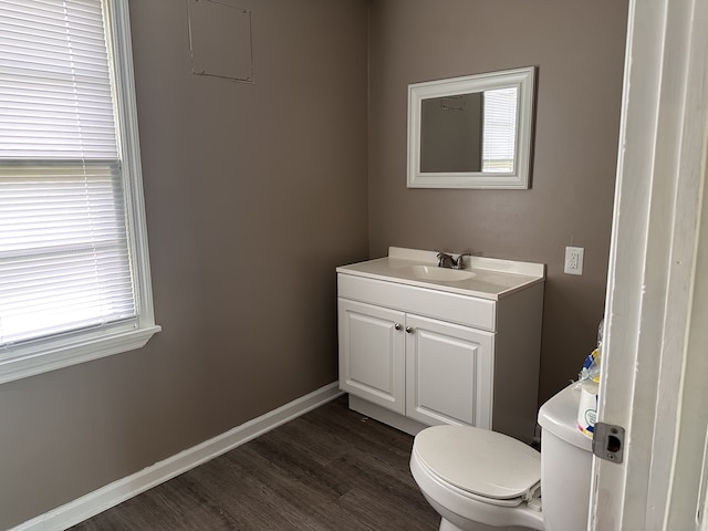 bathroom featuring hardwood / wood-style floors, vanity, and toilet