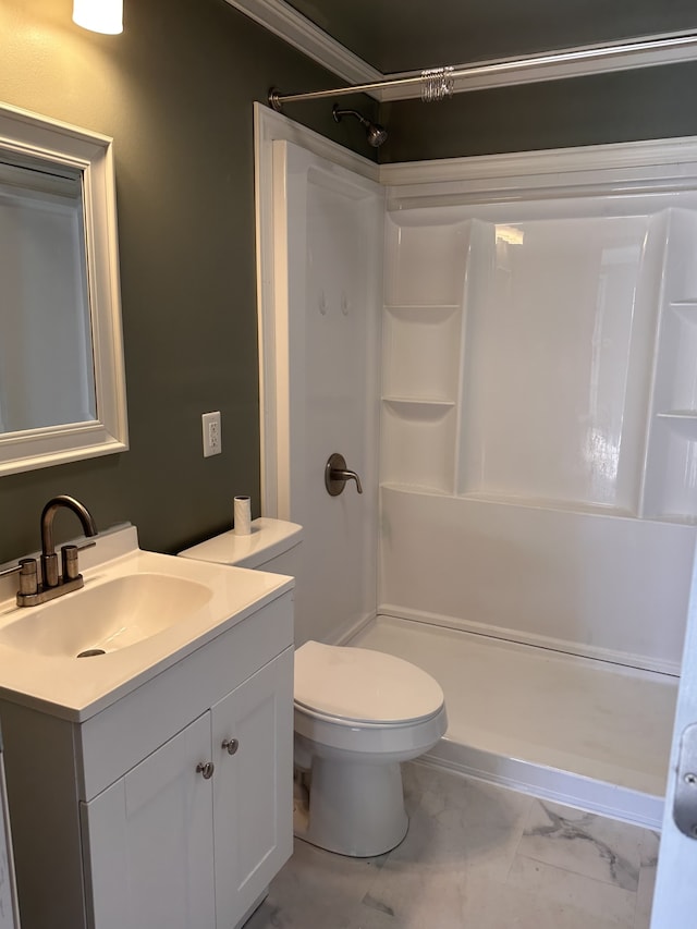 bathroom featuring vanity, toilet, walk in shower, and crown molding