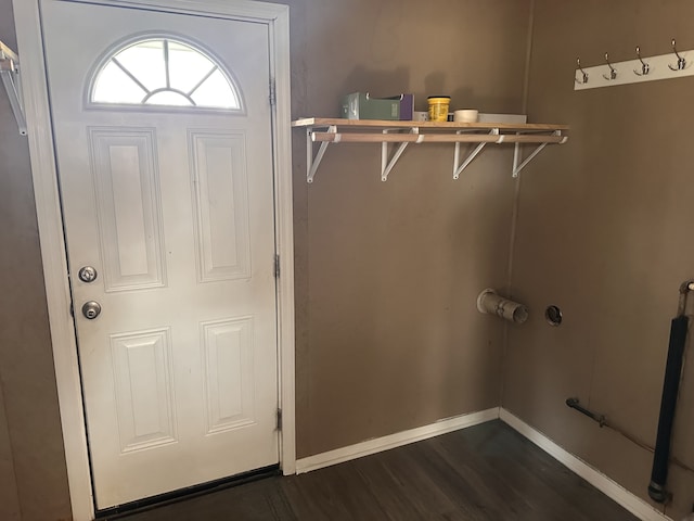 laundry area with dark wood-type flooring