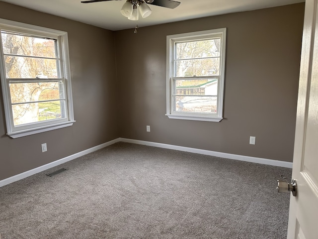 unfurnished room with ceiling fan and carpet