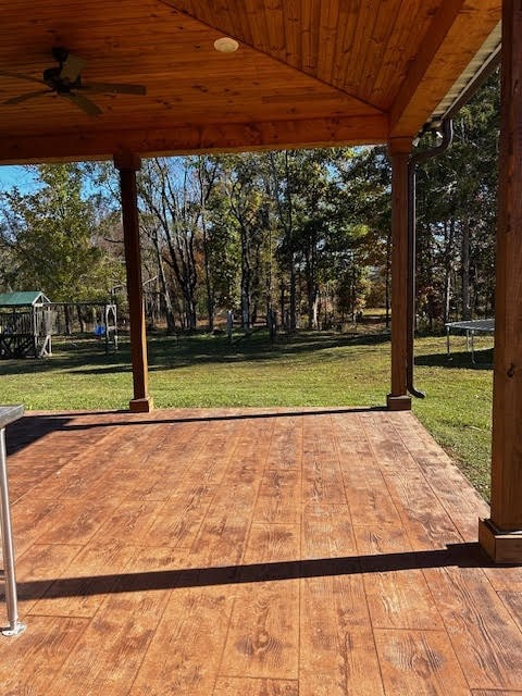 view of patio with a playground, ceiling fan, and a trampoline