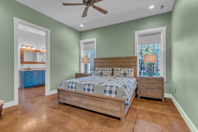 bedroom featuring ensuite bath, ceiling fan, and sink