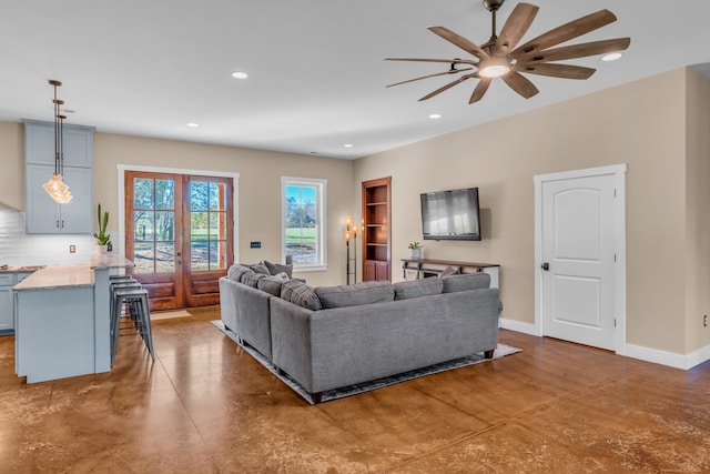 living room featuring ceiling fan and french doors