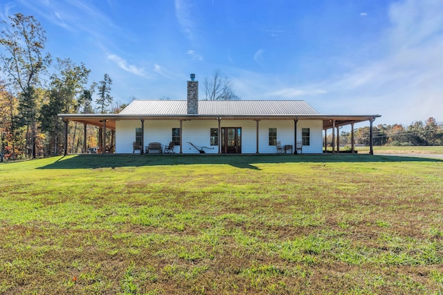 back of house with a lawn