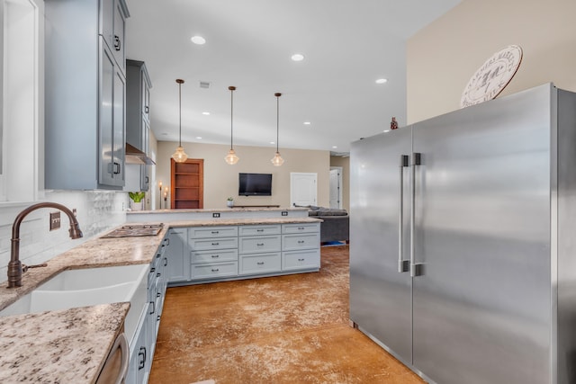 kitchen featuring gray cabinetry, sink, pendant lighting, decorative backsplash, and appliances with stainless steel finishes