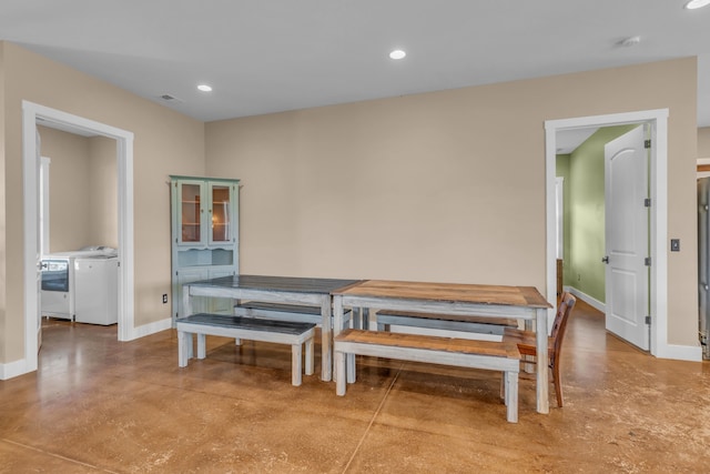 dining area with concrete flooring and washer and dryer