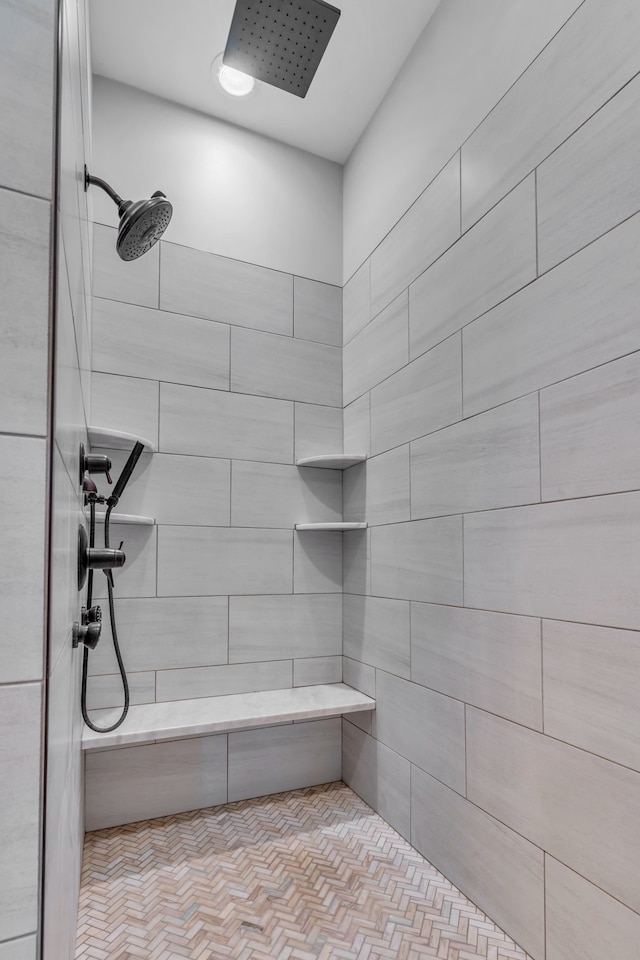 bathroom with tiled shower