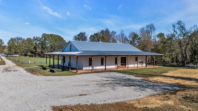 farmhouse-style home with covered porch and a front lawn