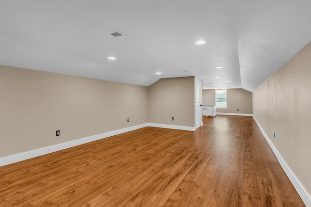 bonus room featuring vaulted ceiling and wood-type flooring