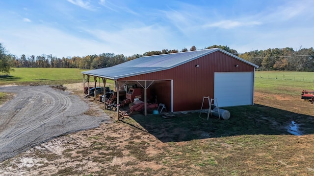 view of outbuilding featuring a rural view and a garage