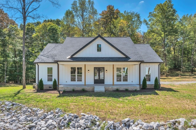 modern inspired farmhouse featuring a front lawn and french doors