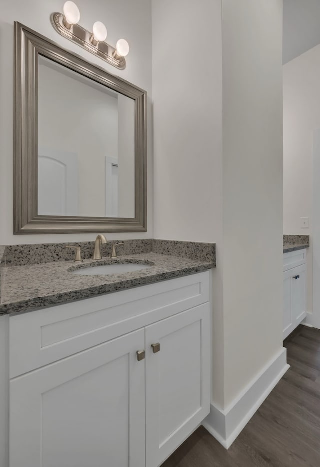 bathroom with vanity and hardwood / wood-style floors