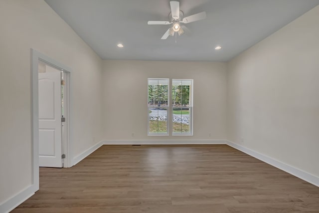 spare room featuring ceiling fan and light hardwood / wood-style flooring